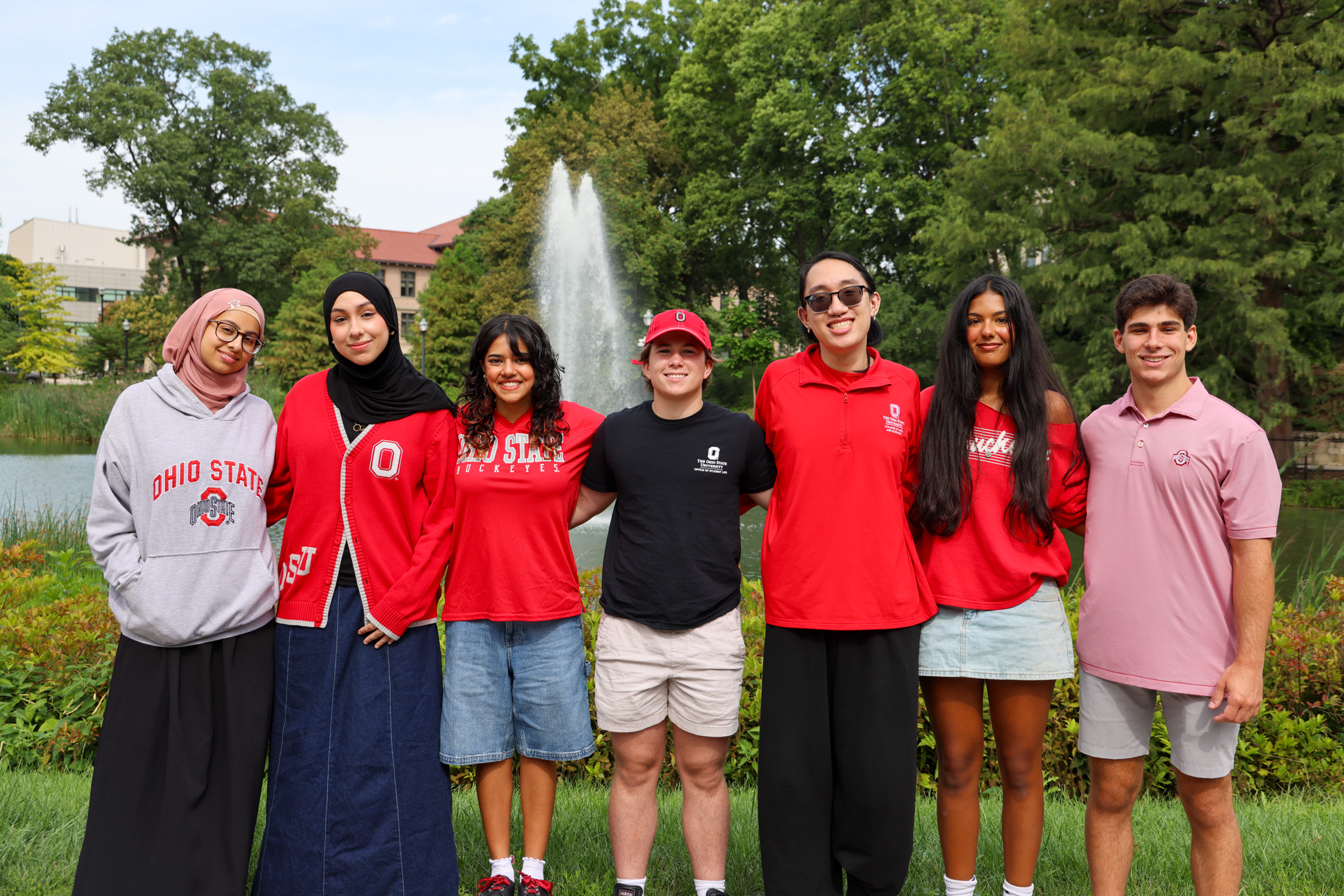 A group of seven individuals stands in front of MIrror Lake on a sunny day. 