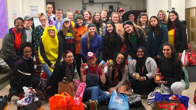 Humanities Scholars students posing as a group dressed in Halloween costumes