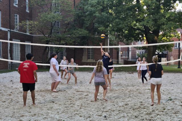 ACES students playing volleyball outside of their residence hall. 