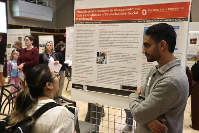 Scholars presenting their research poster at Ohio State research forum