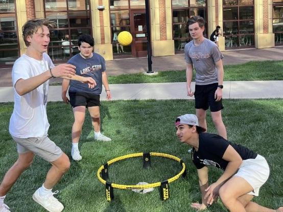 Business Scholars playing yard games outside of Blackburn Hall