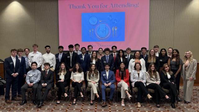 Business Scholars seated together at the closure of a signature event