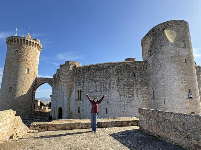 Catie Russ on her study abroad trip standing in front of a castle