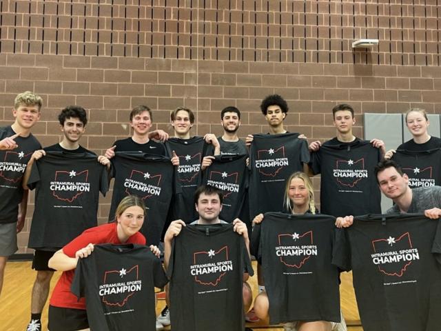 Dunn Sport and Wellness Scholars posing with intramural sport team shirts