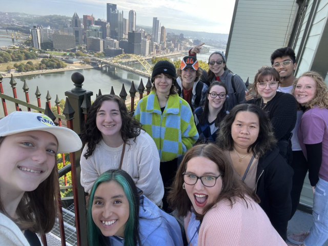 Humanities Scholars pose with the city skyline in the background during their annual trip