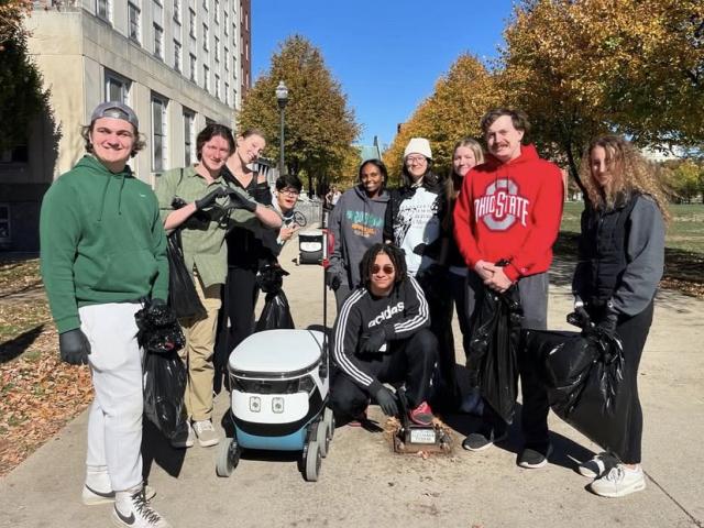 IA Scholars during a community service on campus featuring a robot