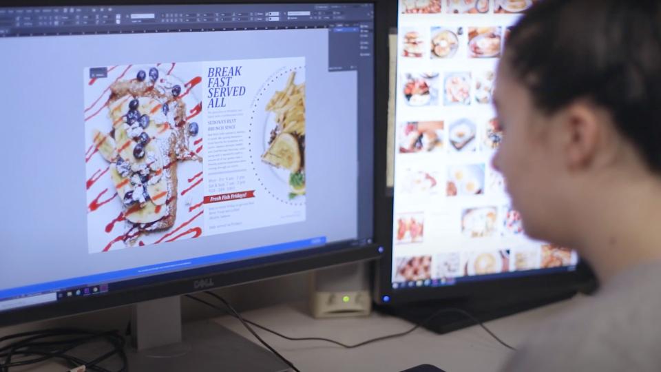 Media student working on a design project on a computer