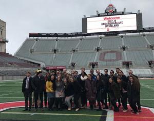 A group of fellowship winners standing on the field at Ohio Stadium.