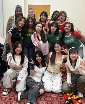 Allison Sachs and 13 other students smile and pose for camera